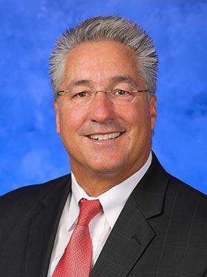 Mark Dambly in a professional head and shoulders photograph.